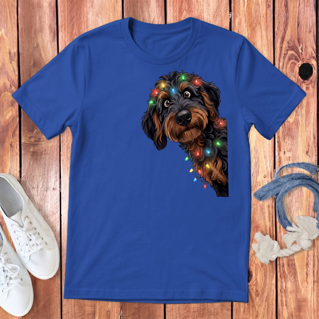 Blue t-shirt with a fluffy dog wearing colorful Christmas lights.