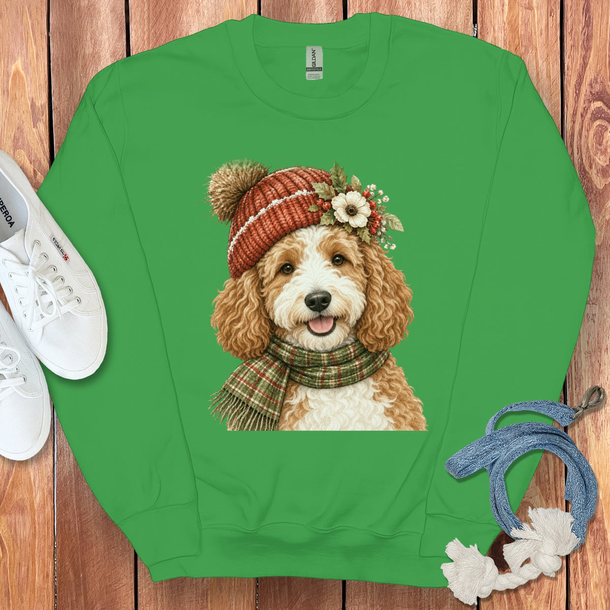 Green crewneck sweatshirt with a drawing of a goldendoodle wearing a winter hat and scarf.