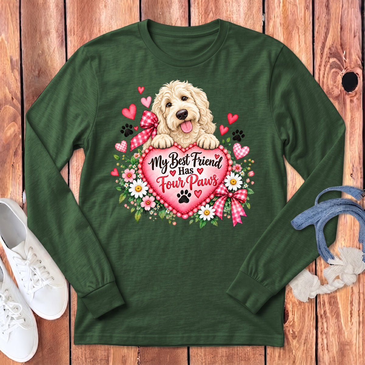 Dark green long-sleeve t-shirt with a graphic of a fluffy dog holding a heart that reads My Best Friend Has Four Paws.