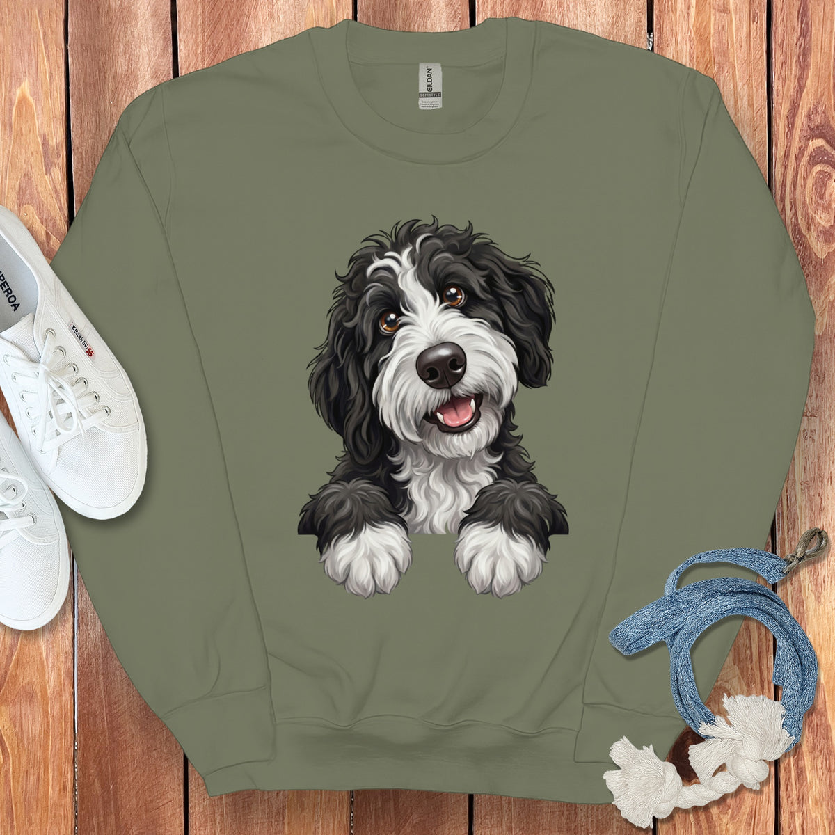Green crewneck sweatshirt with a black and white fluffy dog graphic.