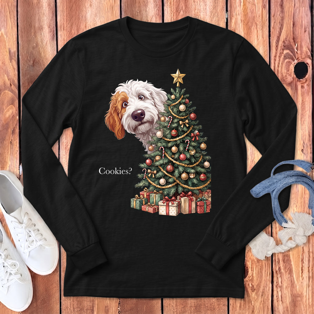 Black long sleeve shirt with a doodle dog peeking behind a decorated Christmas tree and presents.