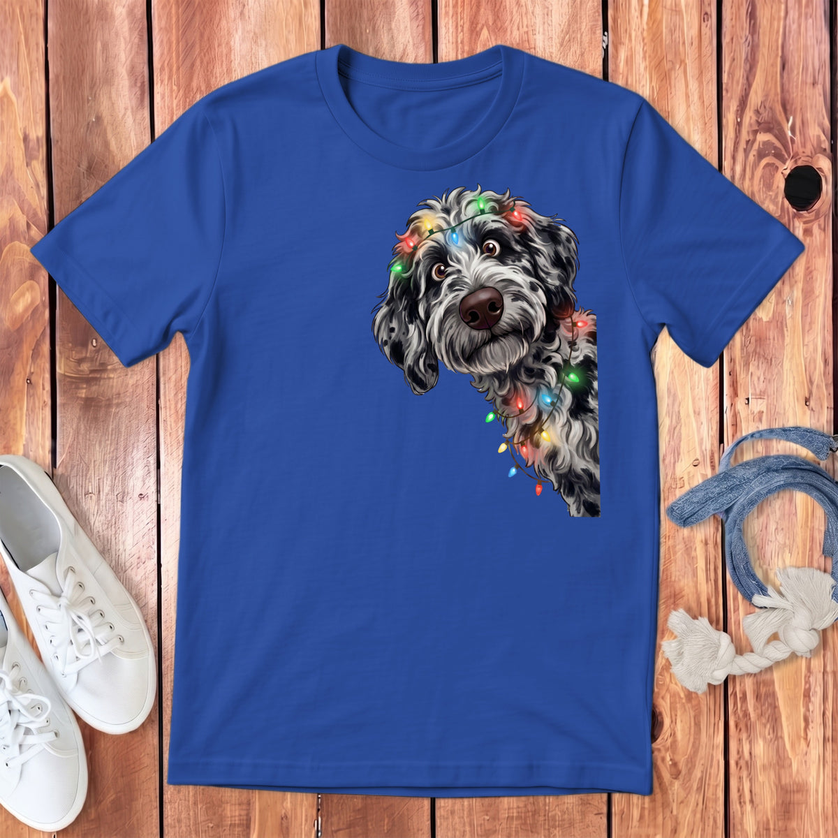 Blue t-shirt with a doodle dog wearing festive Christmas lights.