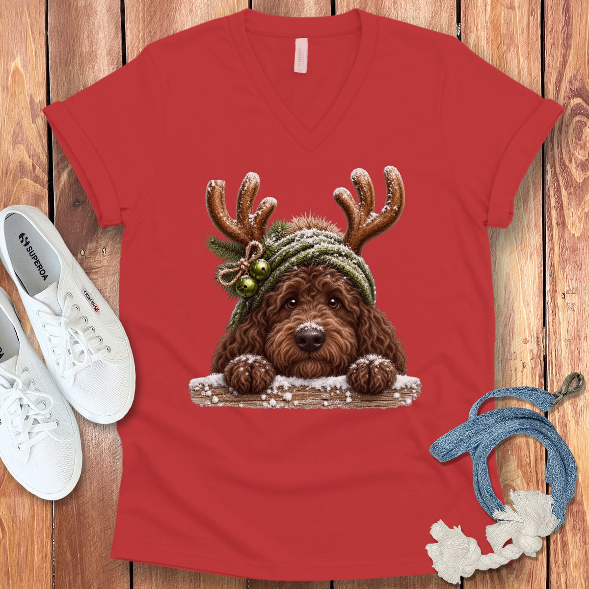 Brown doodle dog wearing reindeer antlers and a green beanie with bells.