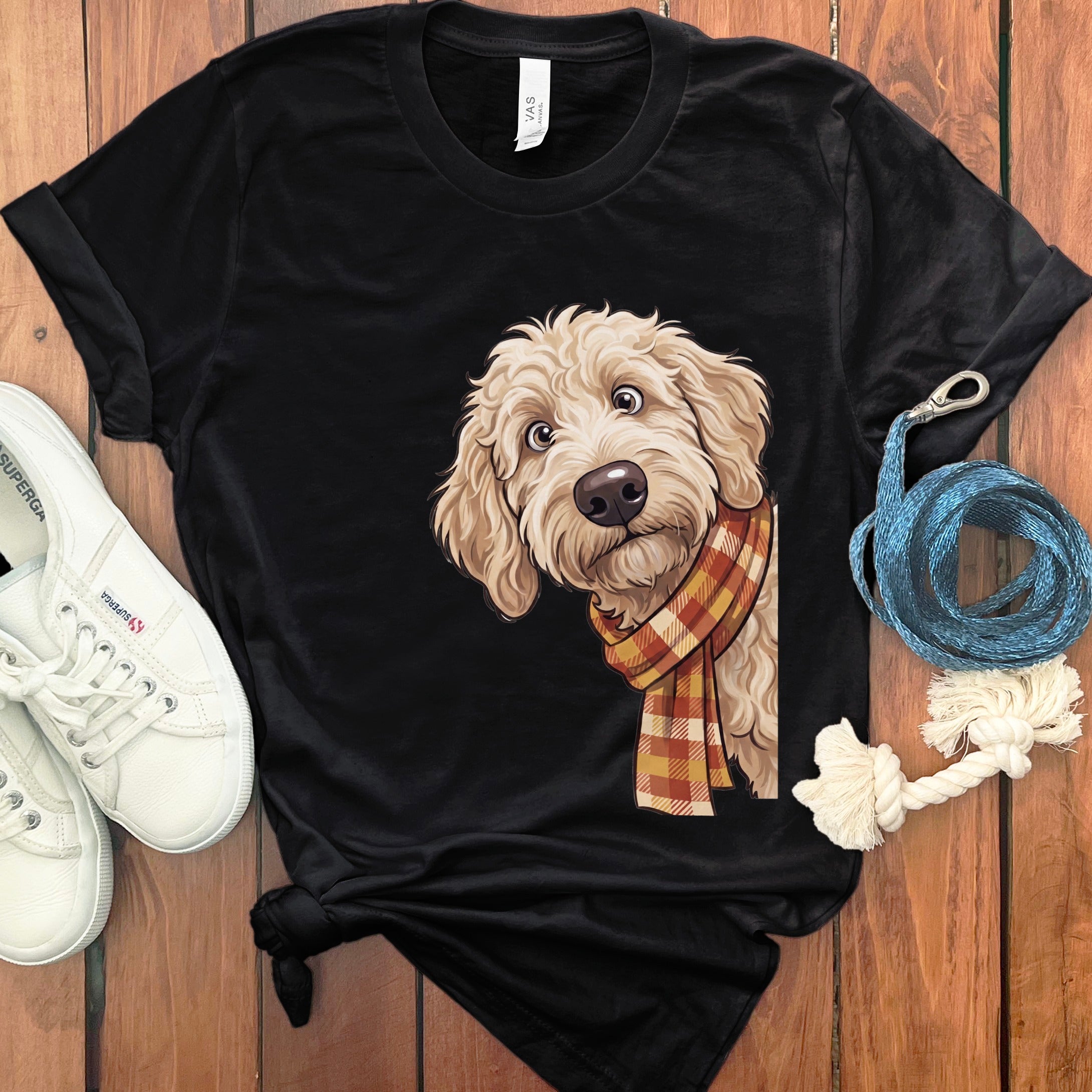 Black t-shirt with illustration of a fluffy dog wearing a plaid scarf.