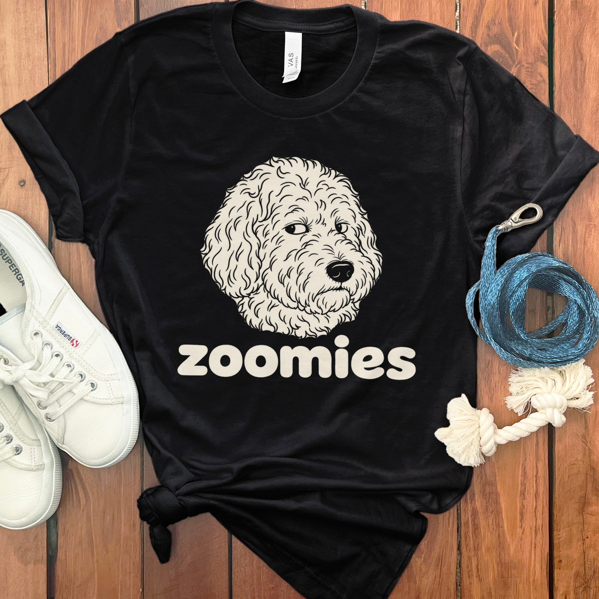 Black t-shirt with cartoon dog face and "zoomies" text.