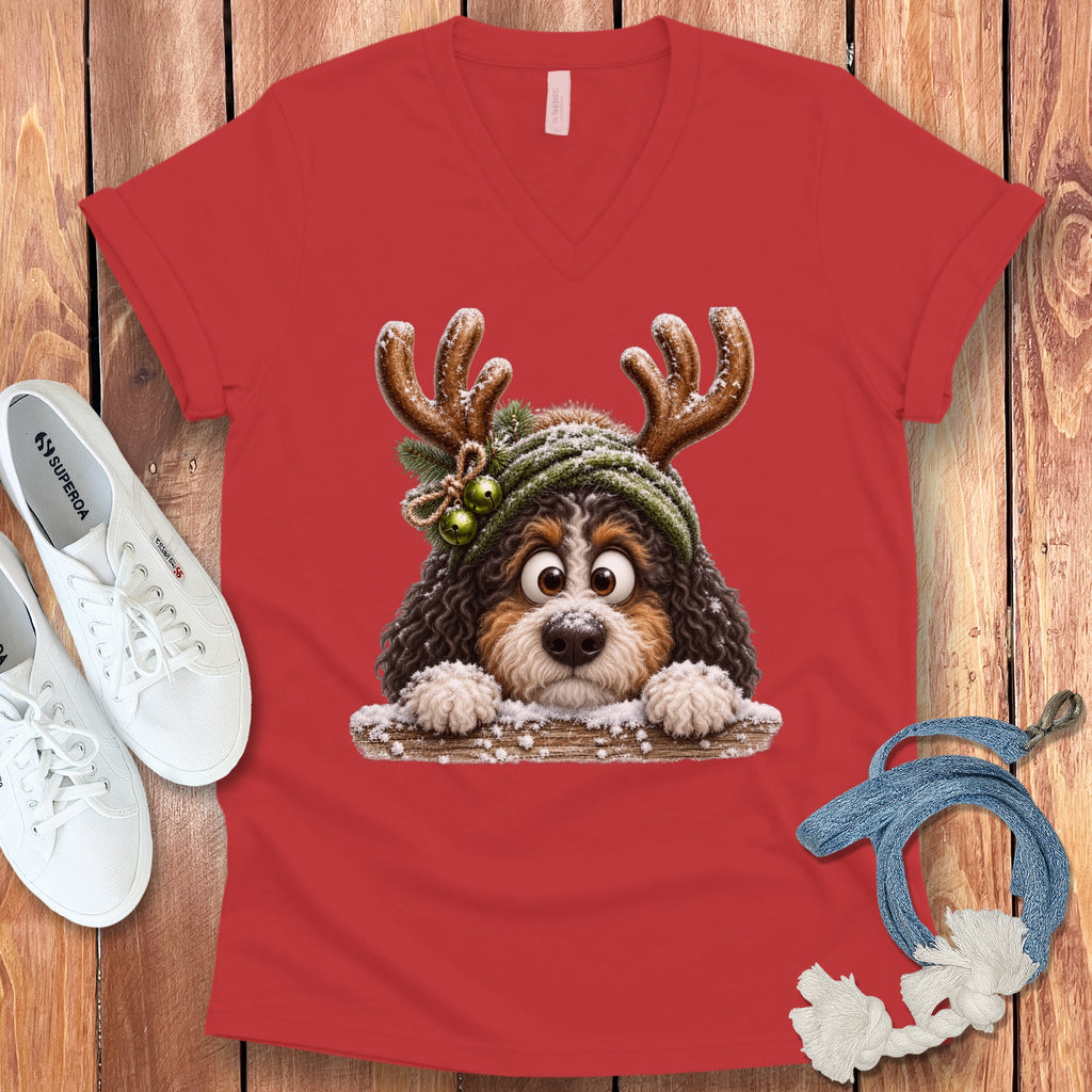 Red t-shirt with a cartoon dog wearing reindeer antlers and snow.