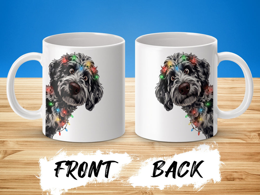 Two white mugs with a black and white dog wearing colorful Christmas lights.