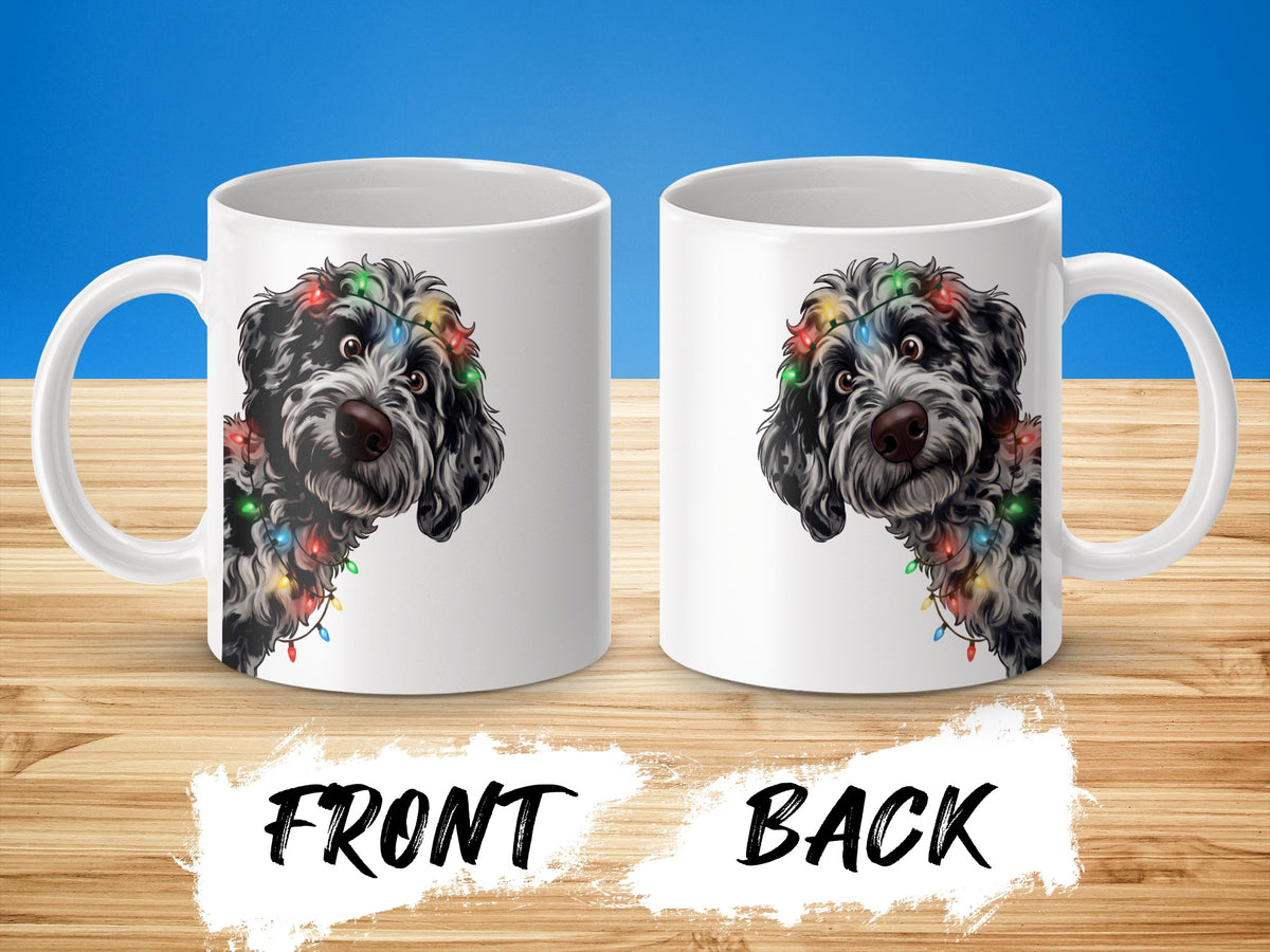 Two white mugs with a black and white dog wearing colorful Christmas lights.