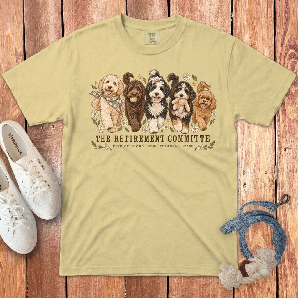 Light yellow t-shirt featuring five doodles and text reading "The Retirement Committee: Five Opinions. Zero Personal Space."