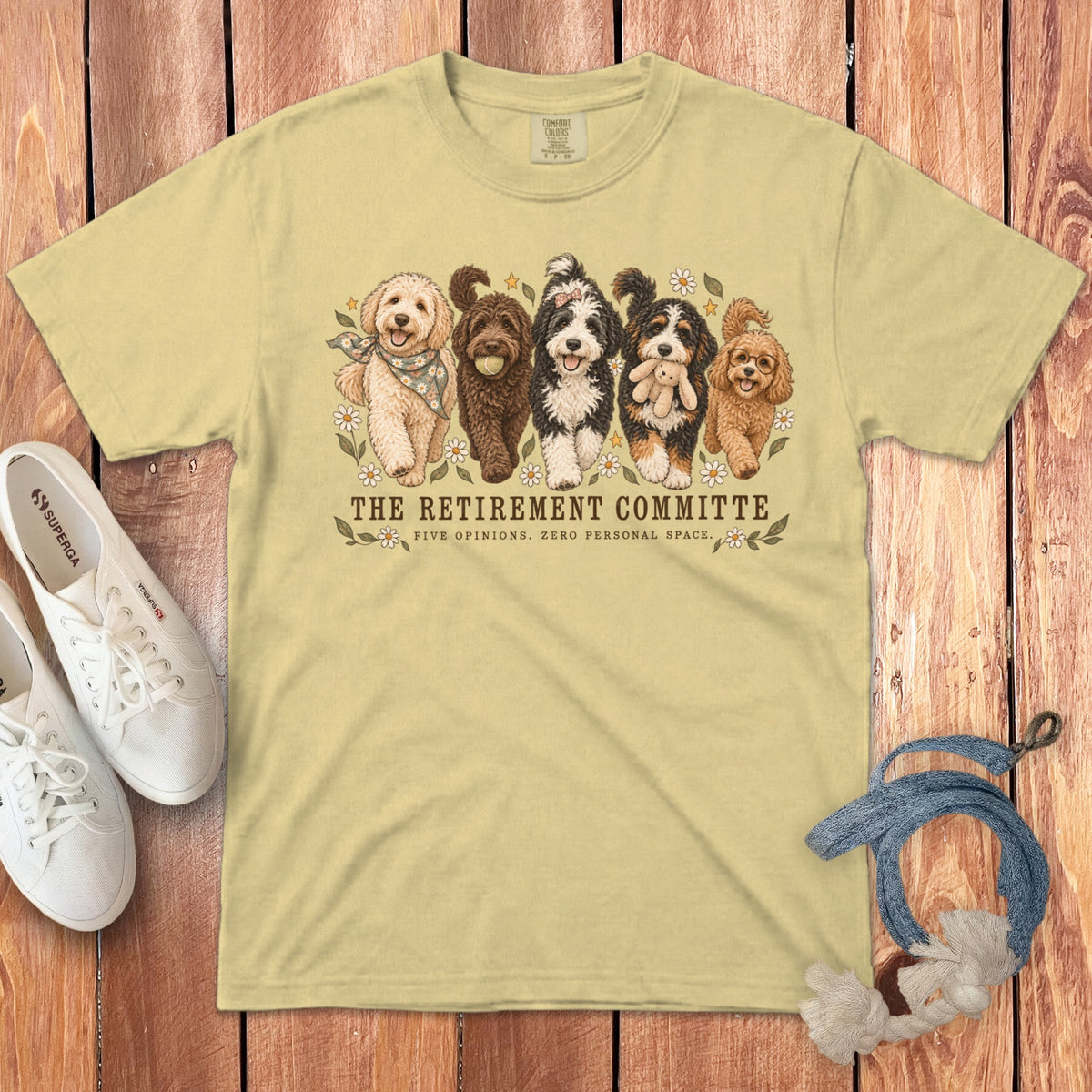 Light yellow t-shirt featuring five doodles and text reading "The Retirement Committee: Five Opinions. Zero Personal Space."