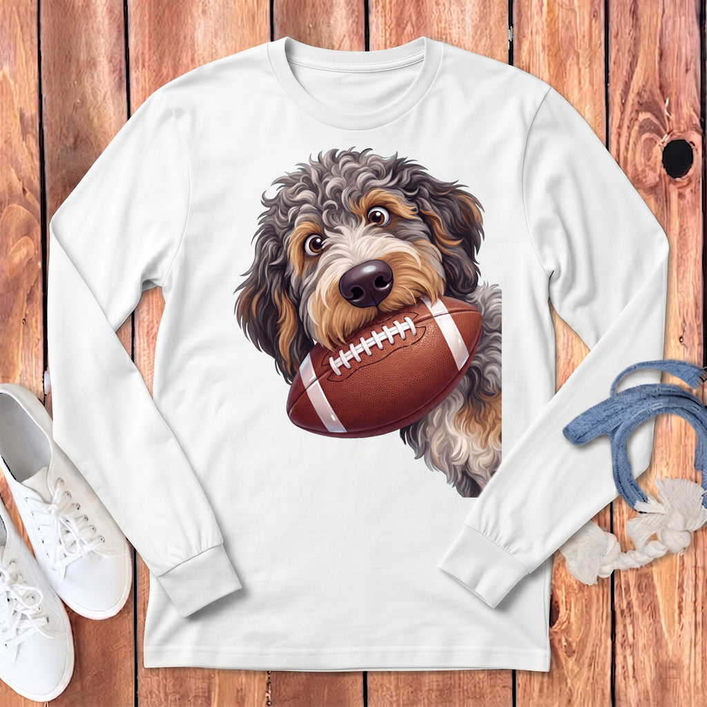 A white long-sleeve t-shirt with a graphic of a fluffy dog holding a football in its mouth.