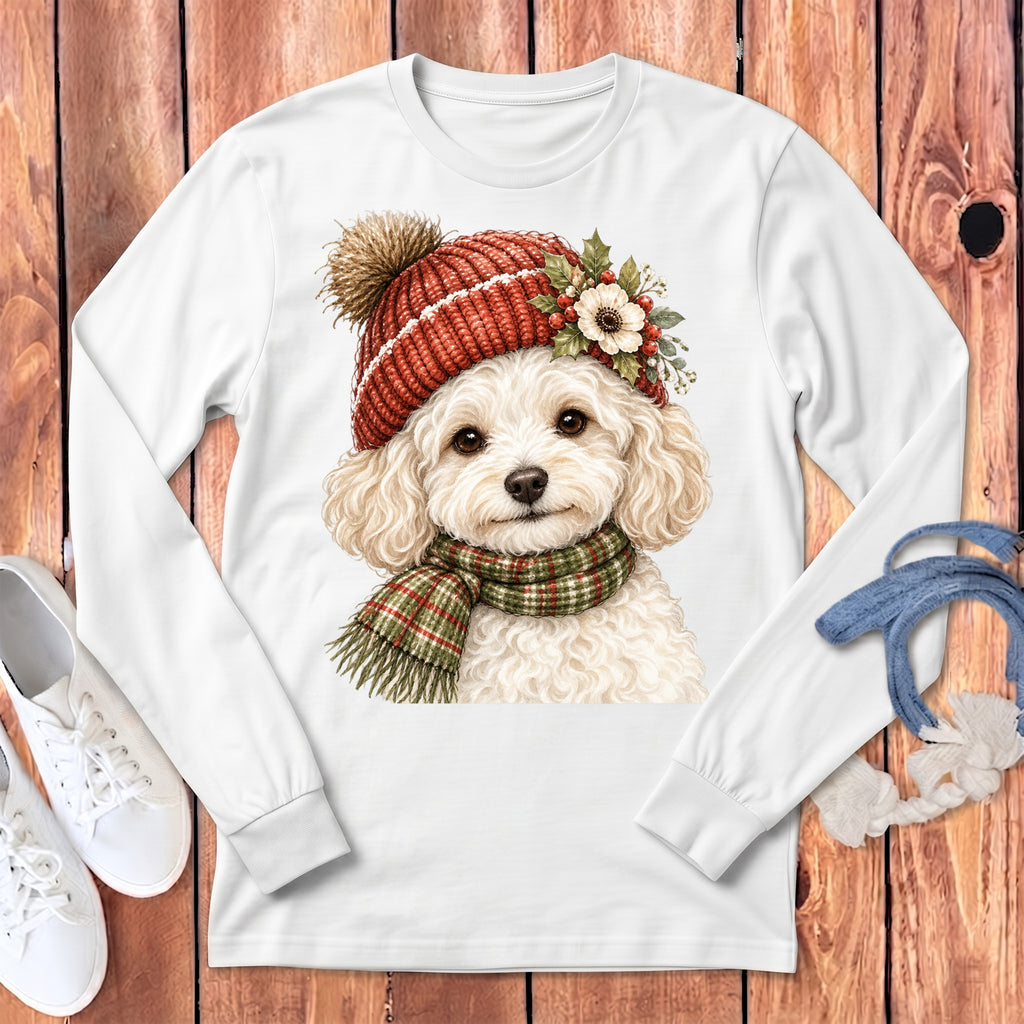 White long-sleeve shirt with a fluffy white dog wearing a red knitted hat and plaid scarf.
