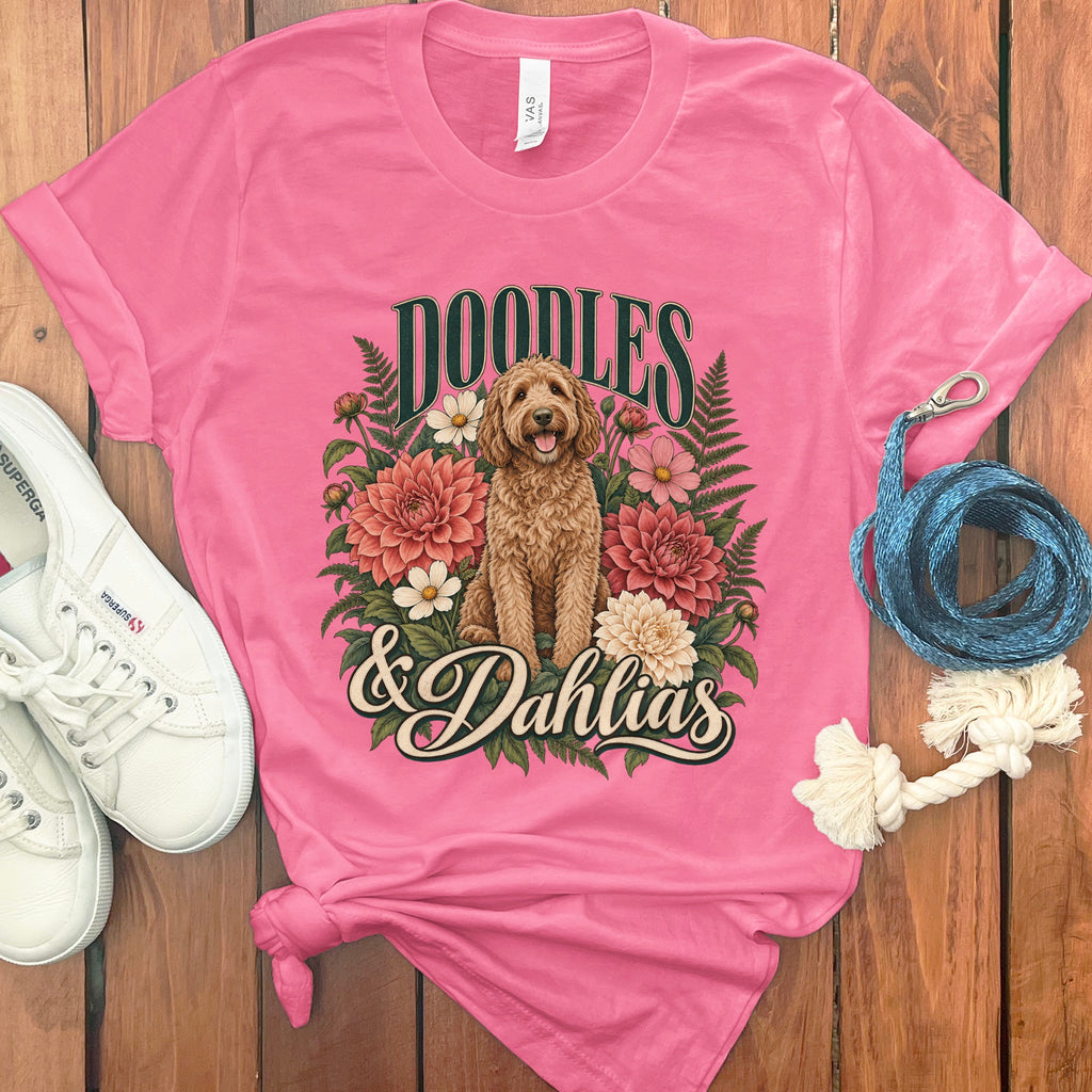 Pink t-shirt with a doodle dog, dahlias, and text "DOODLES & Dahlias".