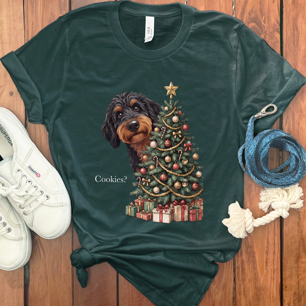 Dark green t-shirt with a dachshund peeking from behind a Christmas tree asking "Cookies?".