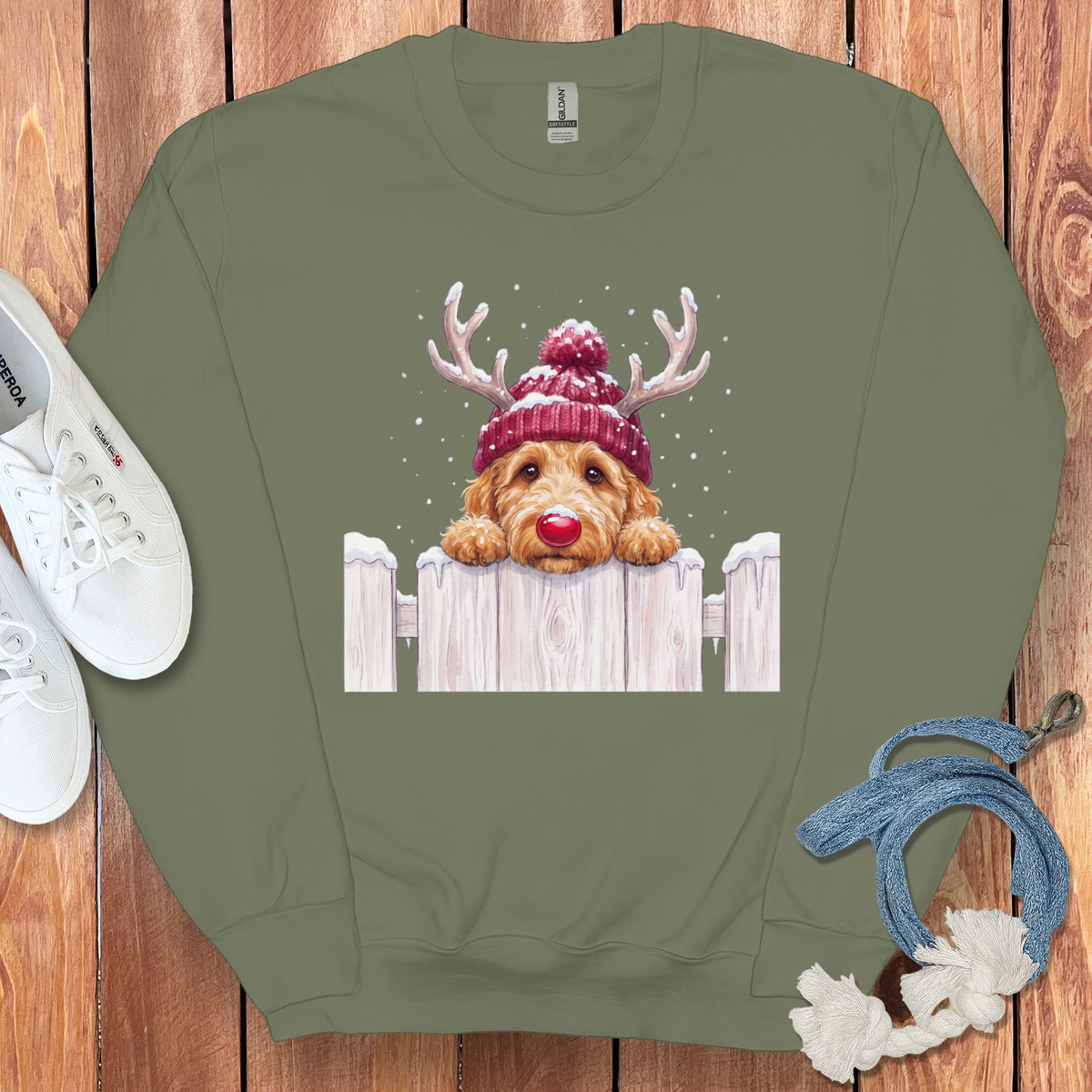 Green sweatshirt with a doodle dog wearing a beanie and reindeer antlers.