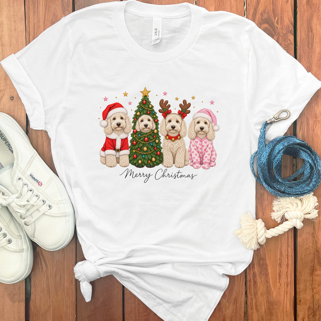 A white t-shirt featuring a graphic of four doodle dogs in Christmas costumes and Merry Christmas text.