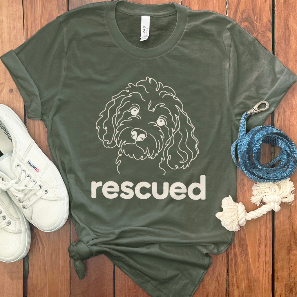 Green t-shirt with a white line drawing of a dog's face and the word "rescued".