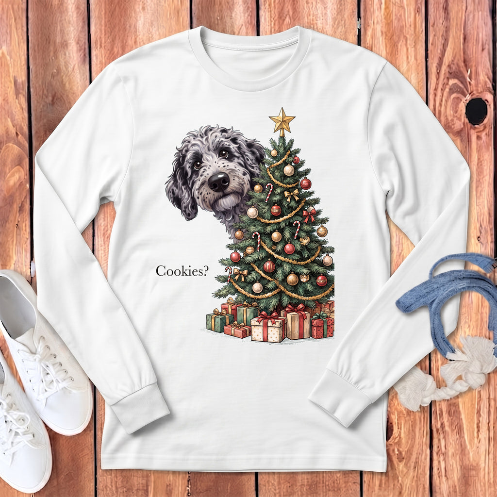 White long sleeve shirt with a dog peeking over a Christmas tree and the text "Cookies?".