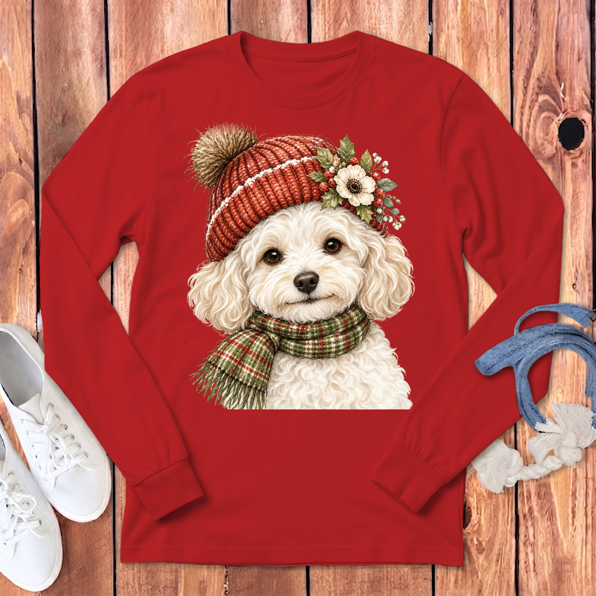 Christmas dog wearing a hat and scarf on a red shirt.