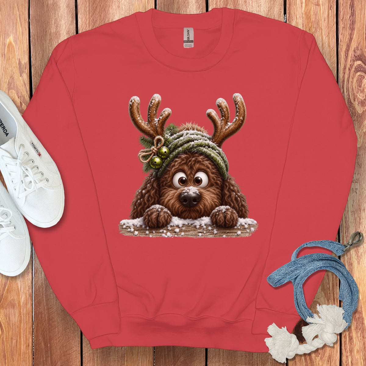 Red sweatshirt with a brown dog wearing reindeer antlers and a green hat.