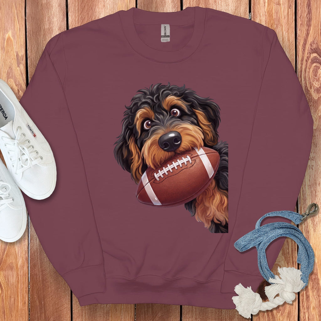 Maroon sweatshirt with a doodle dog holding a football and white sneakers.