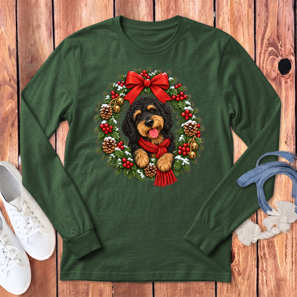 Dark green long-sleeve t-shirt featuring a black and tan dog inside a Christmas wreath.