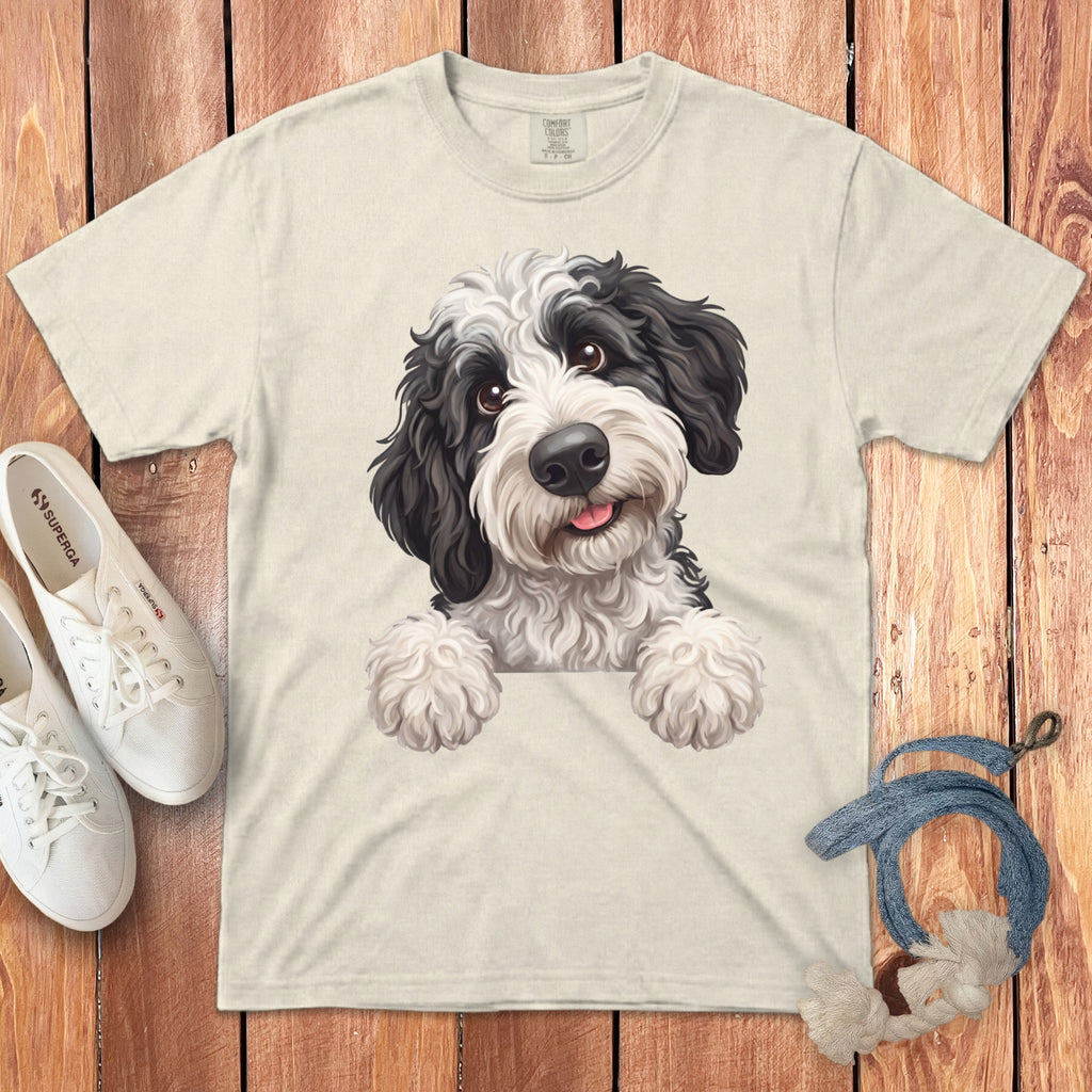 T-shirt with black and white dog graphic, white canvas sneakers, and dog toy.