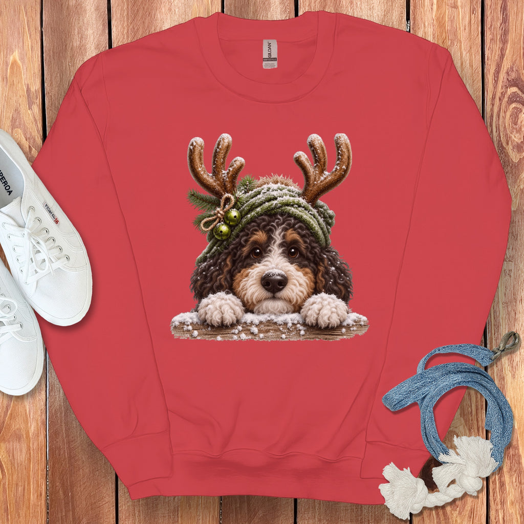 Bernese Mountain Dog puppy wearing reindeer antlers and a green knit hat.