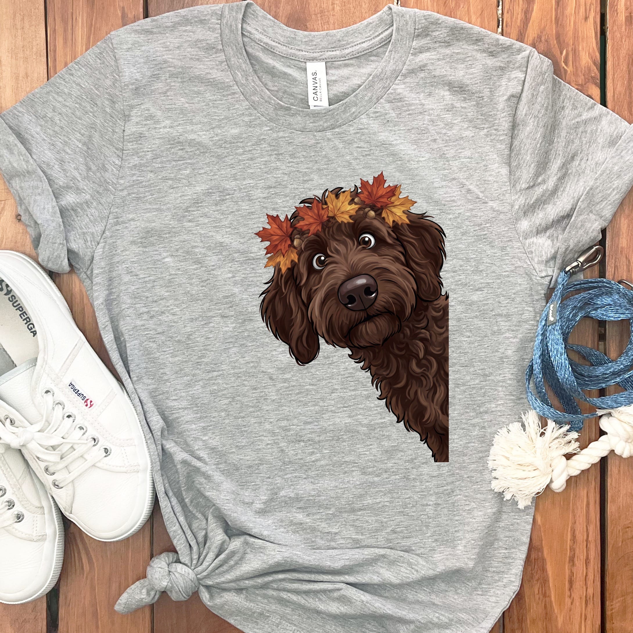 Grey t-shirt with a brown doodle dog wearing a fall leaf and acorn crown.