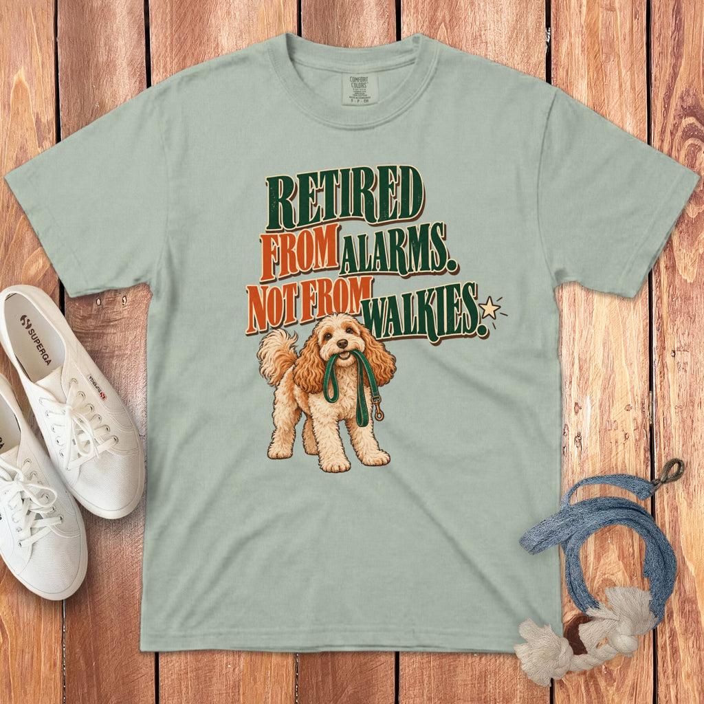Sage green crewneck t-shirt featuring a cartoon dog holding a leash and text reading Retired From Alarms, Not From Walkies.