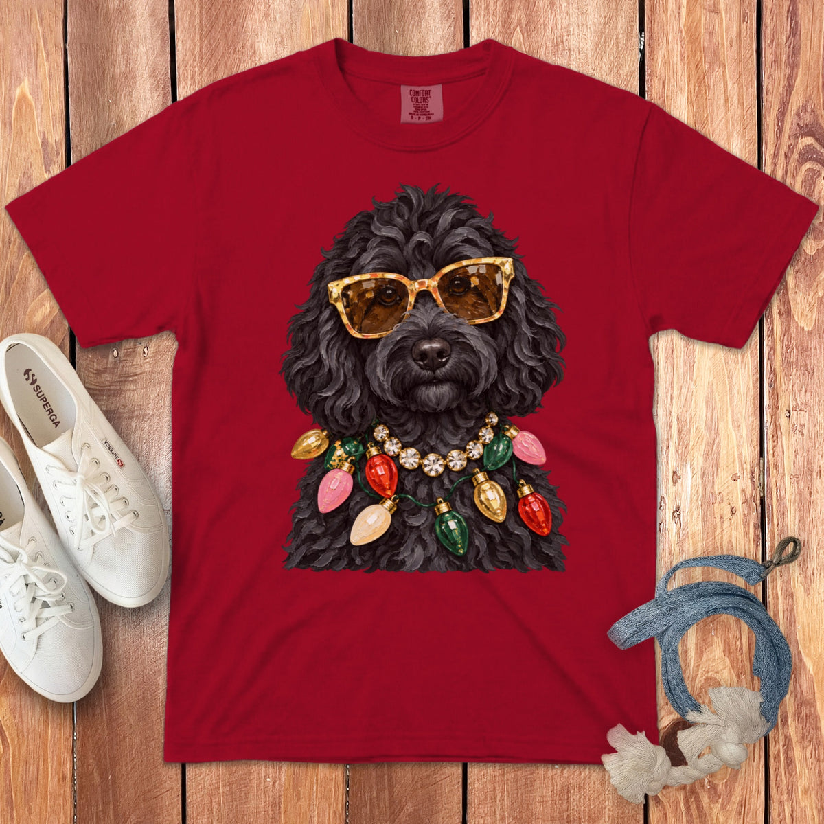 Red t-shirt with a black poodle wearing sunglasses and a string of Christmas lights.