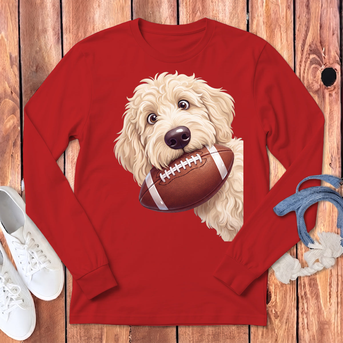 Red long sleeve shirt with a dog holding a football graphic.