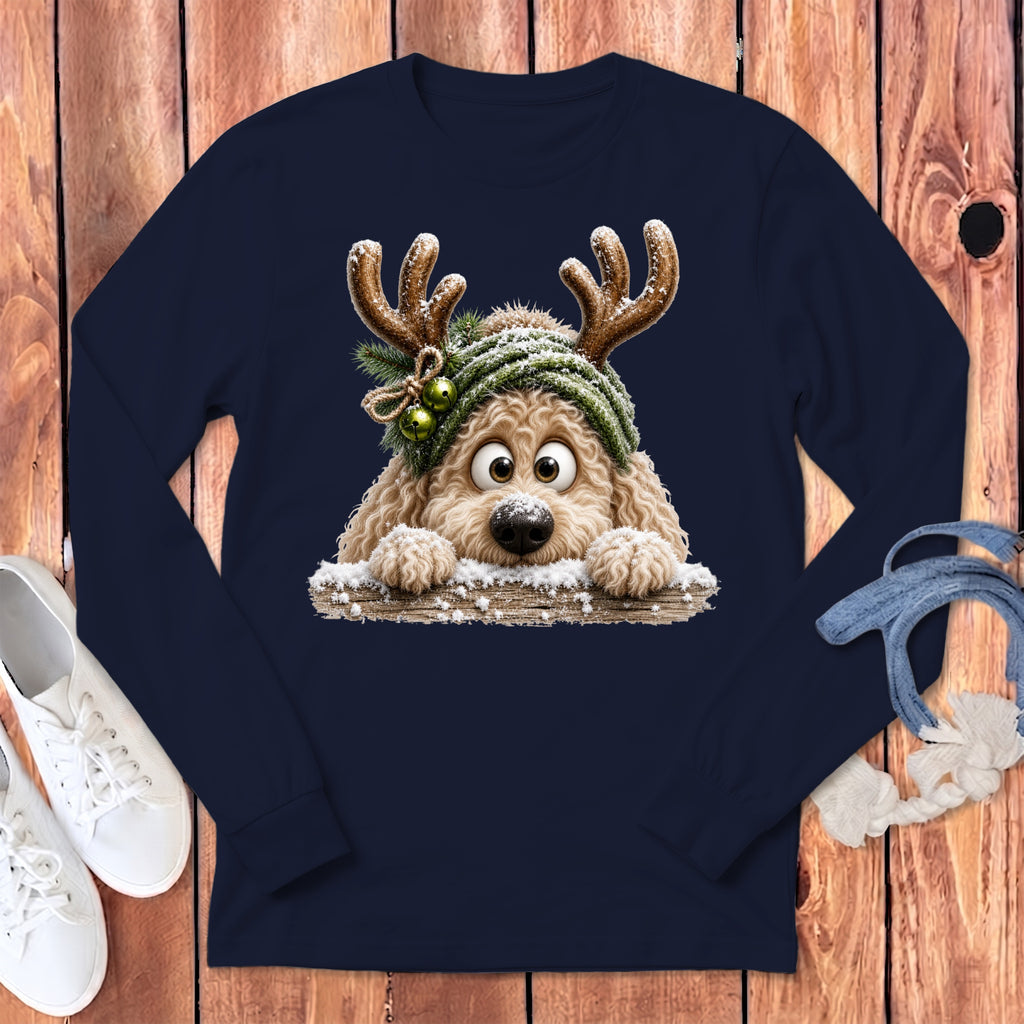 Fluffy dog wearing reindeer antlers and a green hat with bells on a navy long-sleeved shirt.