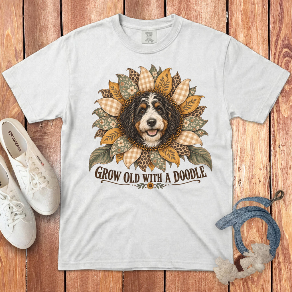 White crewneck t-shirt featuring a doodle dog graphic inside a sunflower, with text reading GROW OLD WITH A DOODLE.