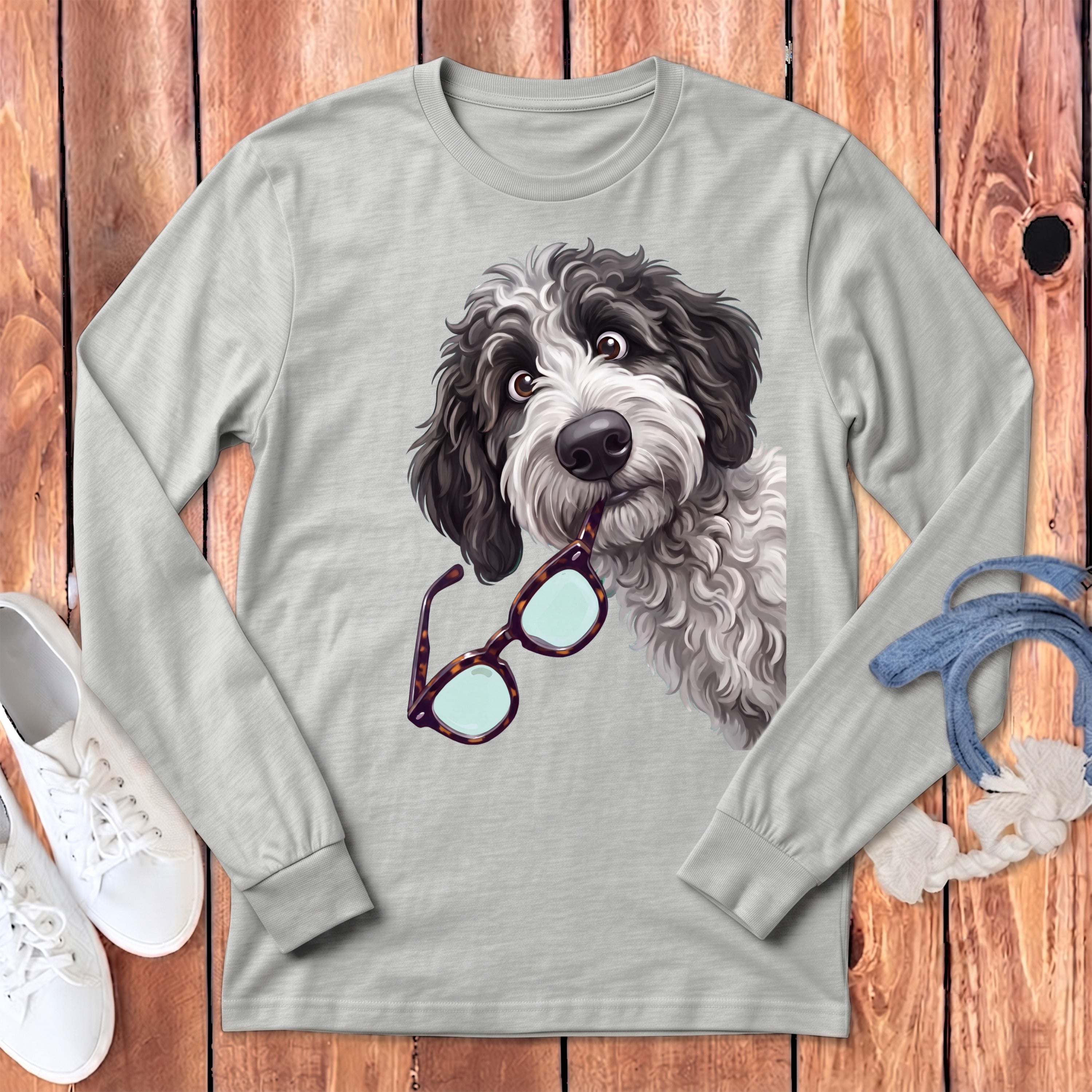 A long-sleeve light gray t-shirt featuring a cartoon doodle dog holding glasses in its mouth.