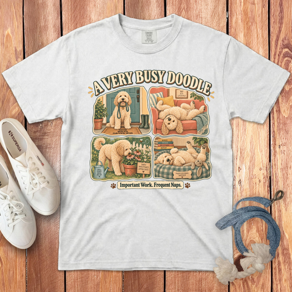 White t-shirt with cartoon doodles titled "A Very Busy Doodle" and "Important Work. Frequent Naps."