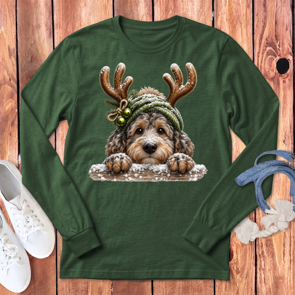Green long sleeve shirt with a doodle dog wearing reindeer antlers and a beanie.