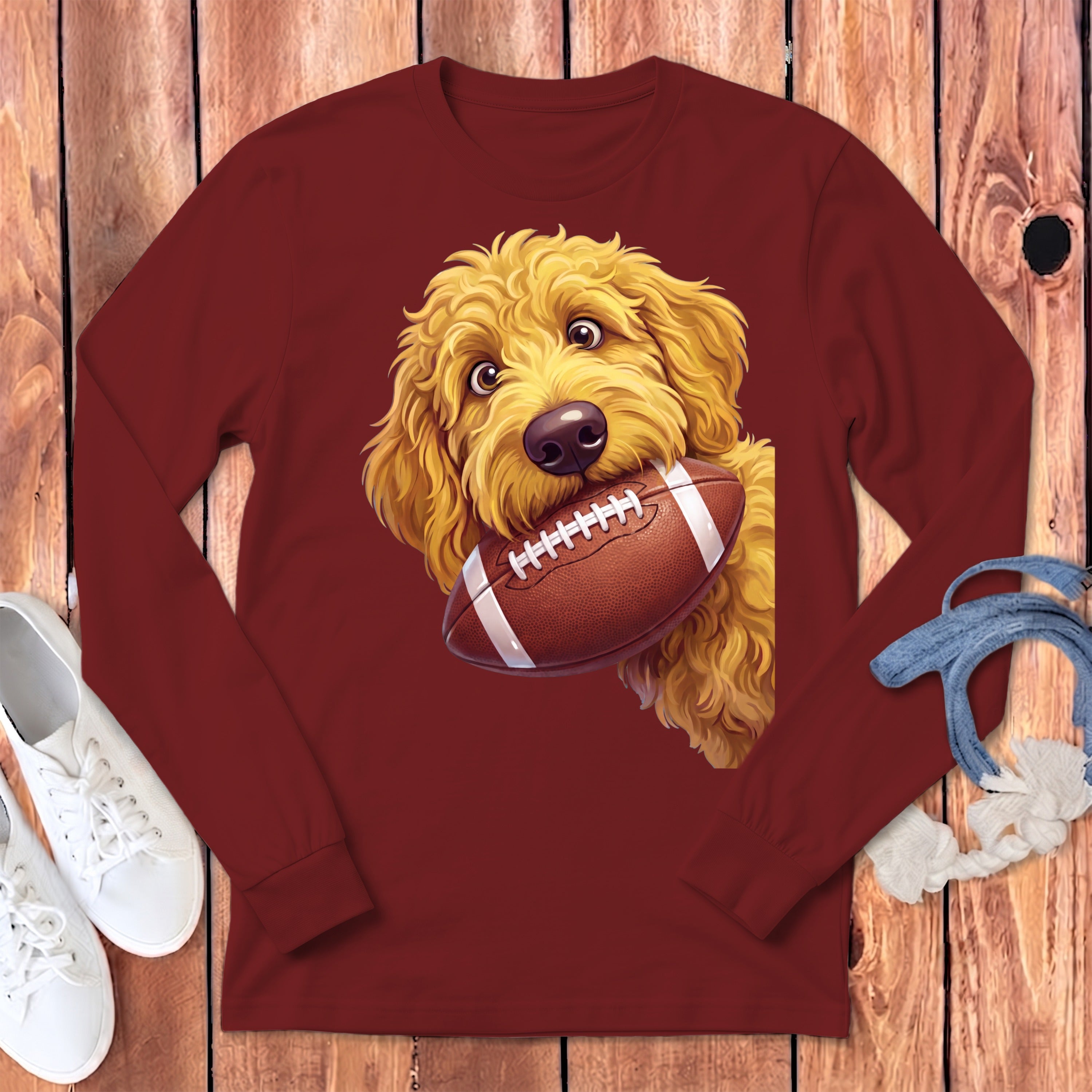 Maroon long sleeve shirt featuring a cartoon doodle holding a football.
