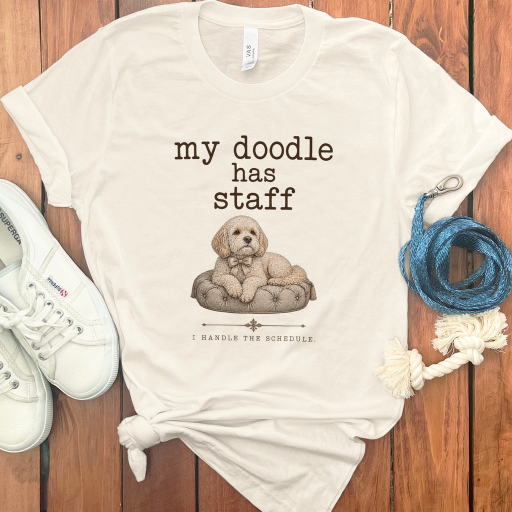 Cream t-shirt with text "my doodle has staff" and illustration of a dog.