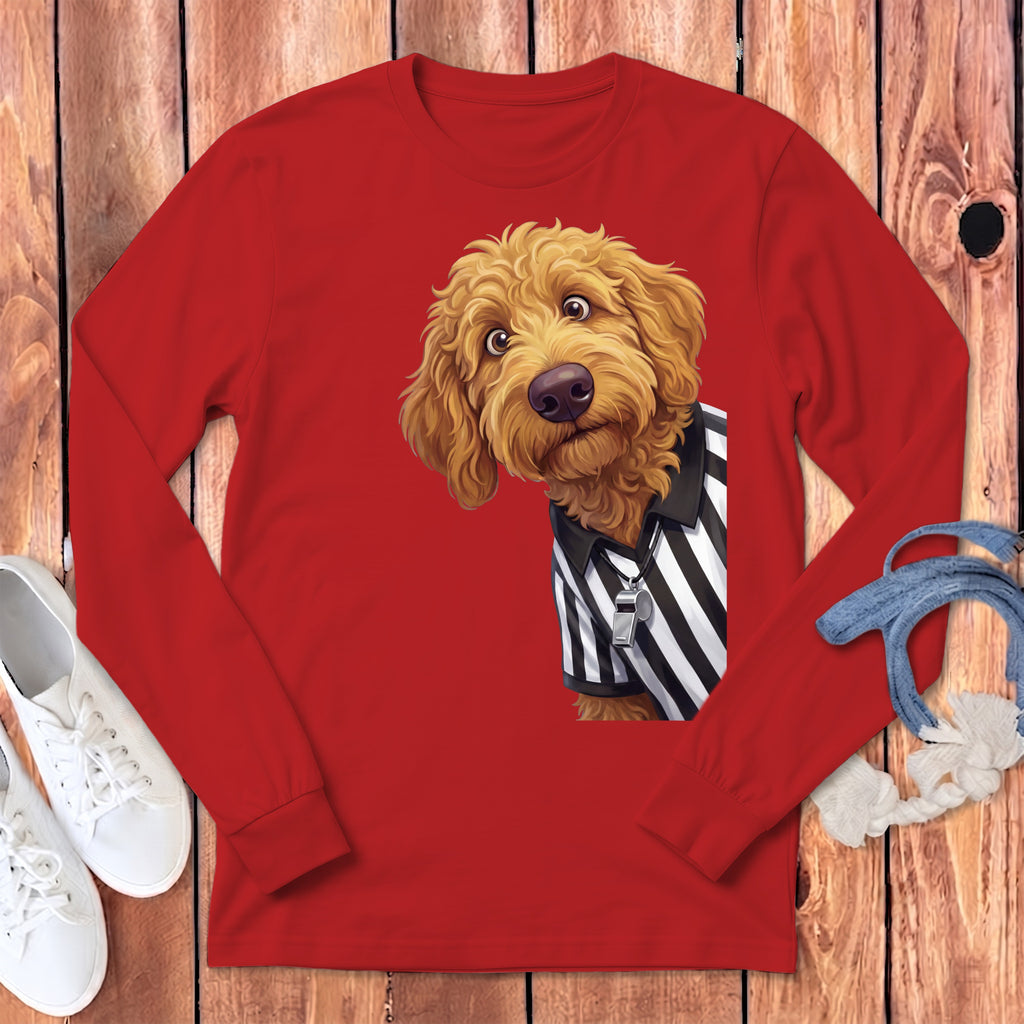 Golden doodle wearing a black and white striped referee shirt and a whistle.
