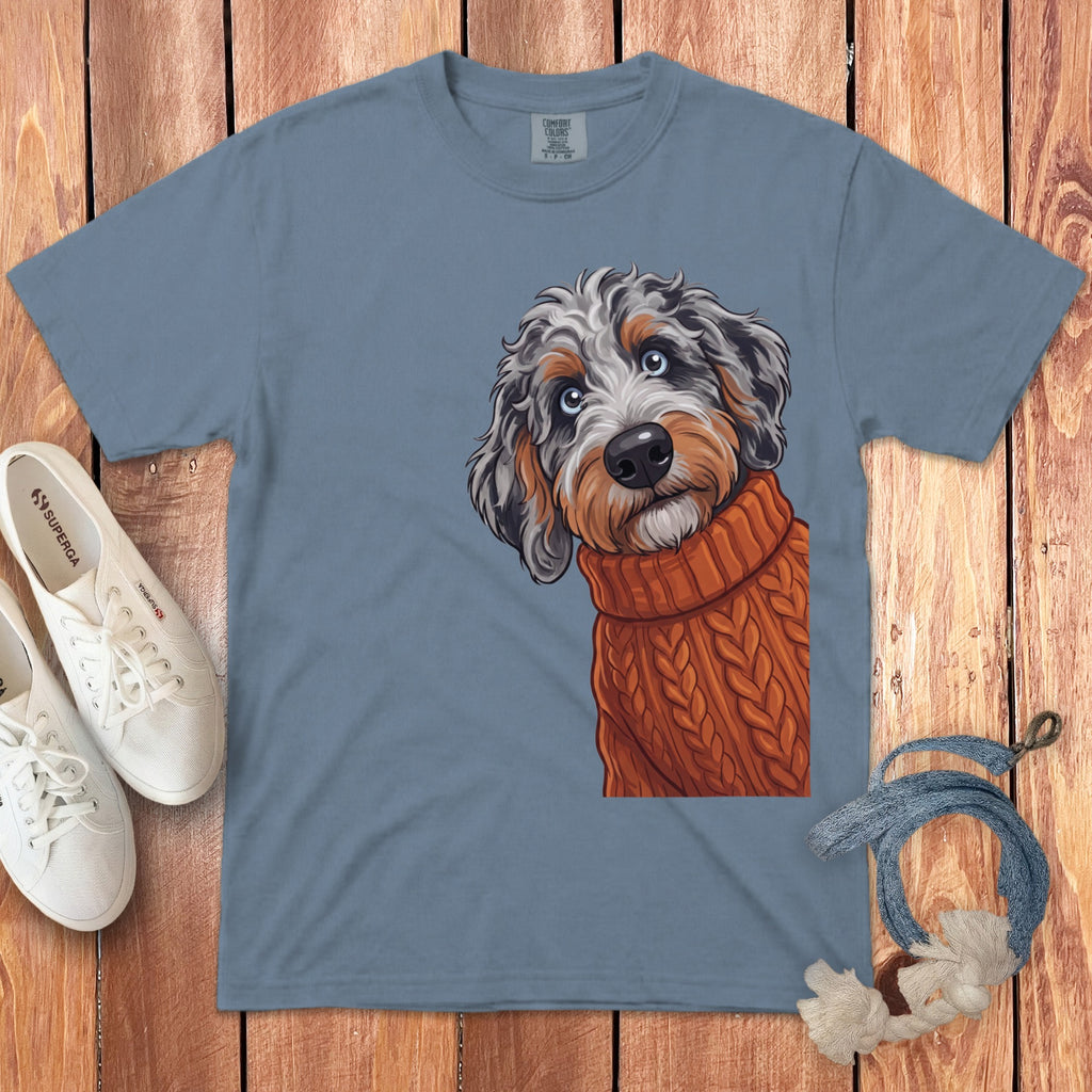 Blue t-shirt with a playful doodle of a partially visible dog wearing an orange sweater.