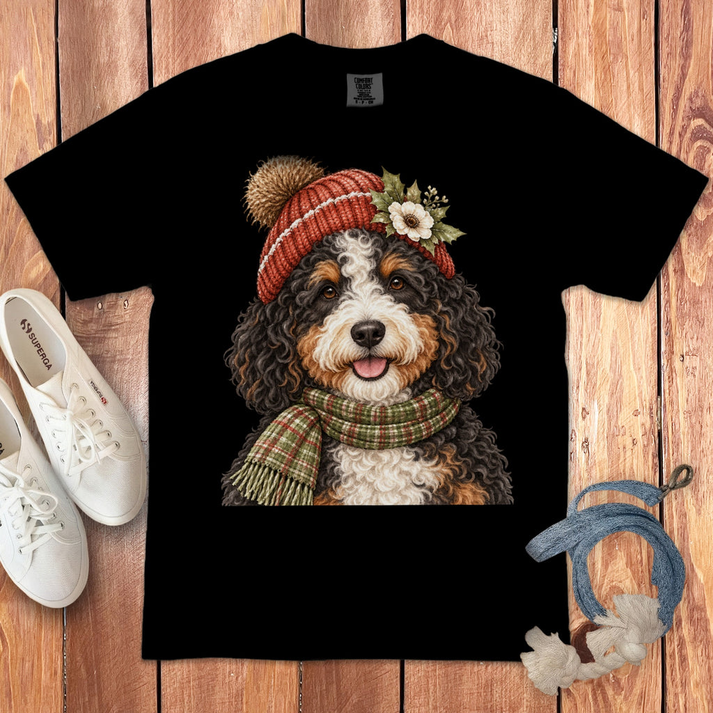 Black t-shirt with Bernese Mountain Dog wearing a knitted hat and scarf.