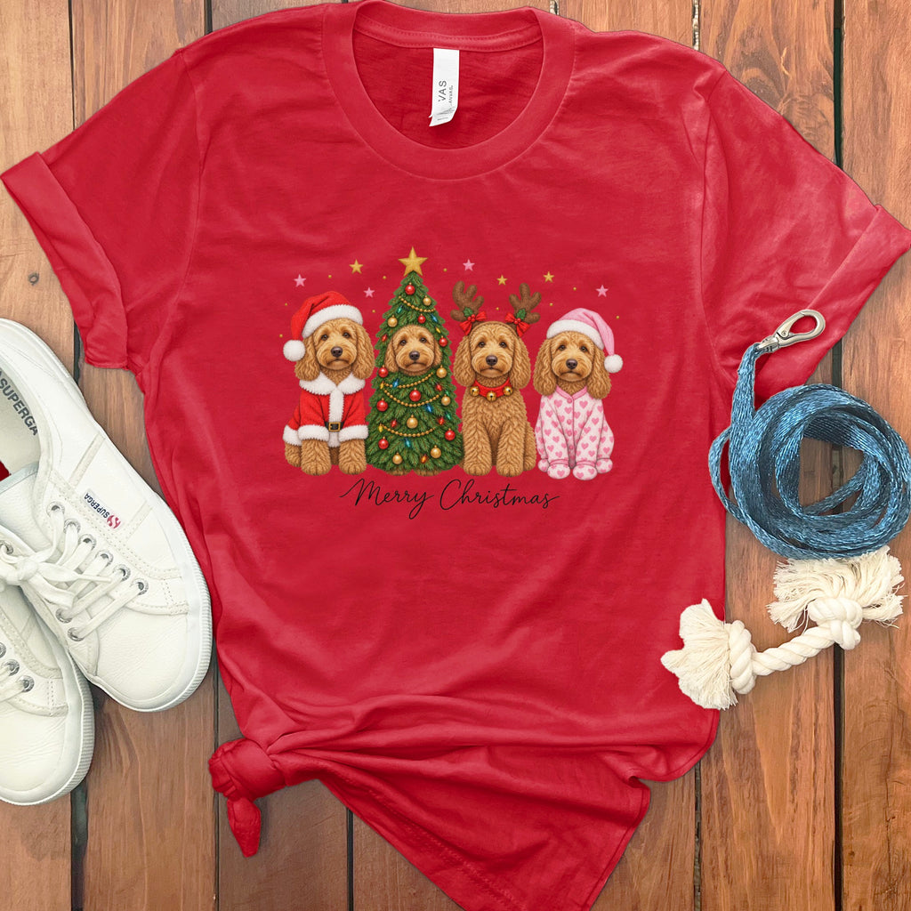 A red t-shirt with a graphic of four doodle dogs celebrating Christmas, surrounded by sneakers and a leash.