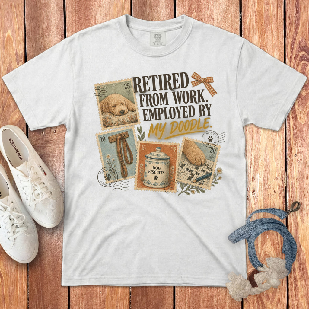 White t-shirt with vintage-style postage stamp illustrations and text reading Retired From Work Employed By My Doodle.