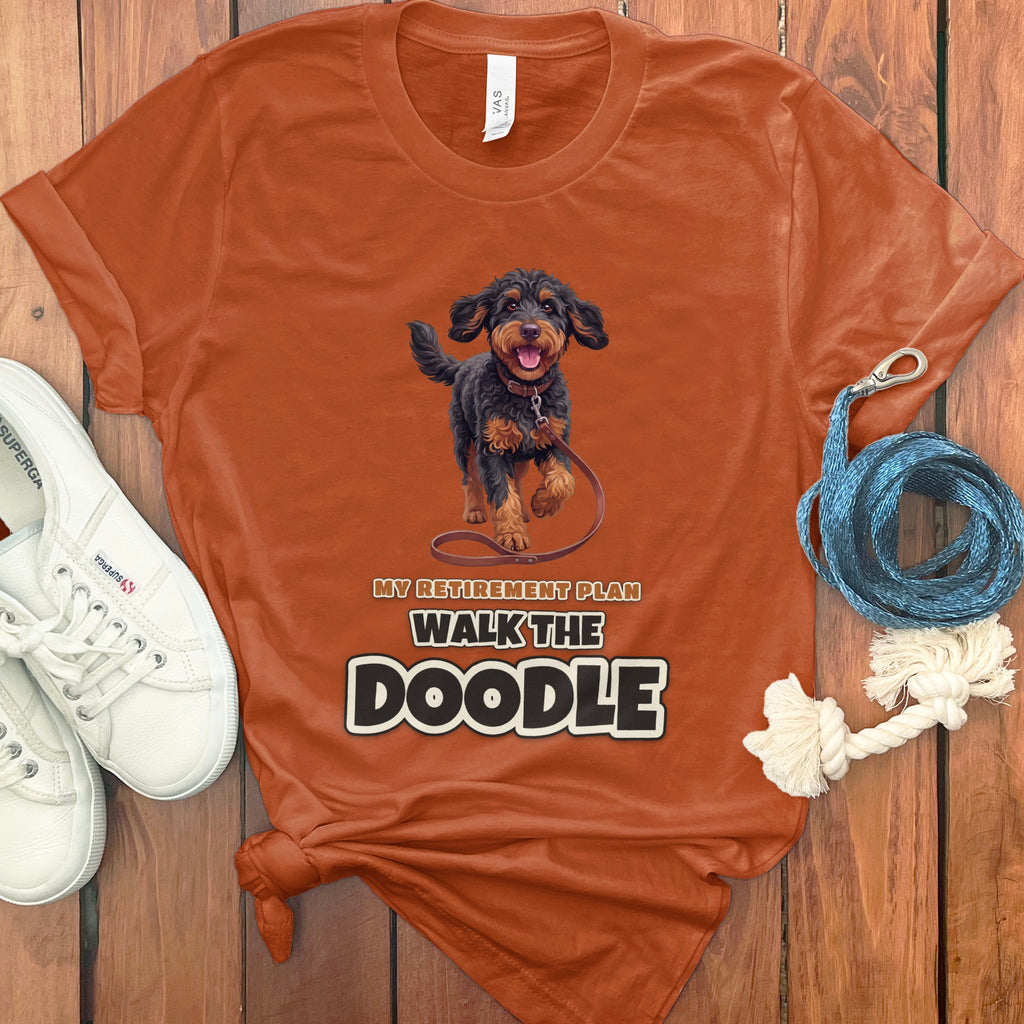 Orange t-shirt with a doodle dog graphic and text "MY RETIREMENT PLAN WALK THE DOODLE".