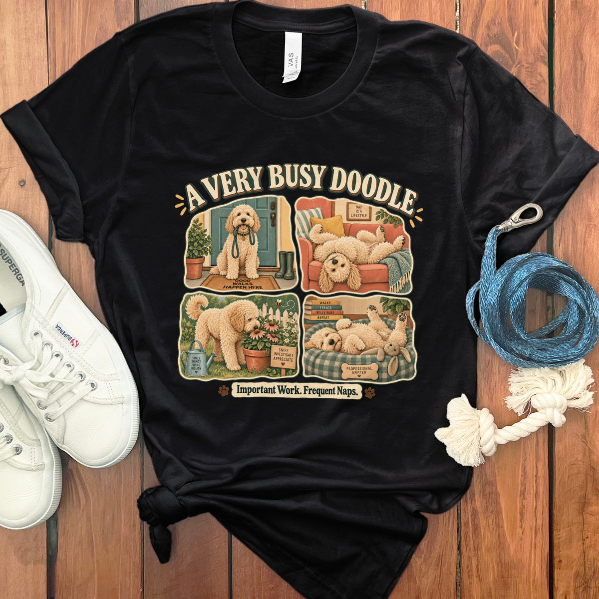 Black t-shirt with a four-panel illustration of a doodle dog and text.