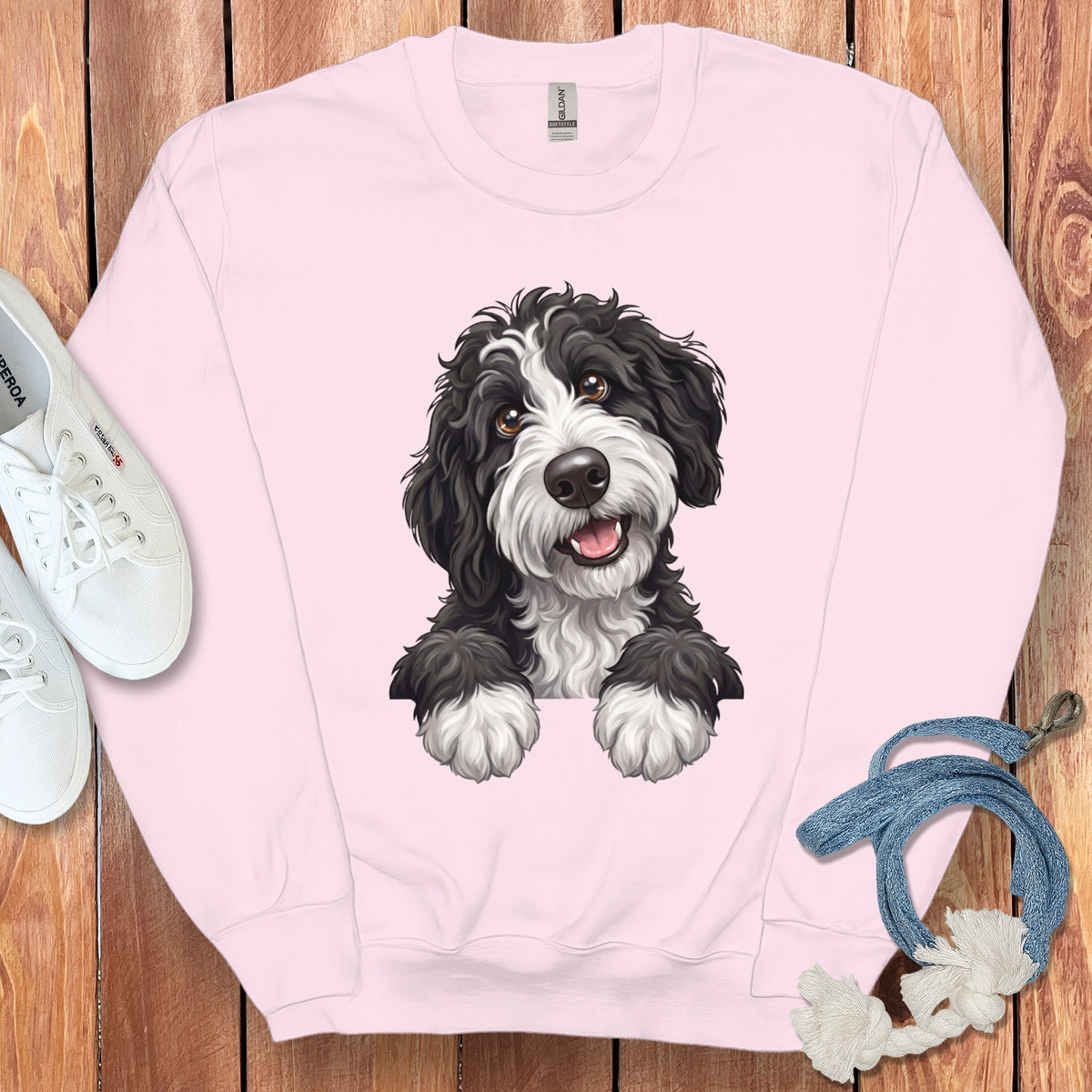 Pink crewneck sweatshirt with a black and white fluffy dog graphic.