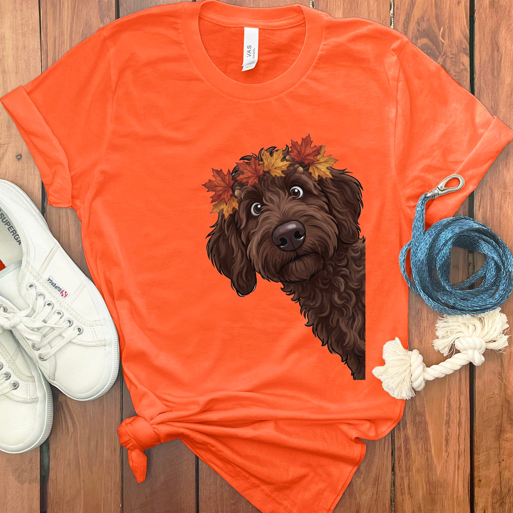 Orange t-shirt featuring a brown dog wearing a fall leaf crown.