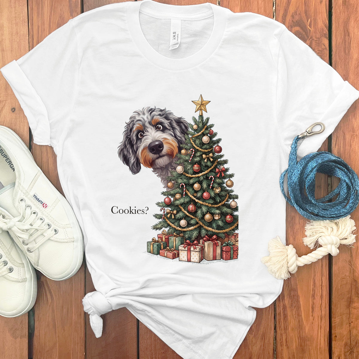 White t-shirt with a doodle of a dog and Christmas tree, text reads "Cookies?".