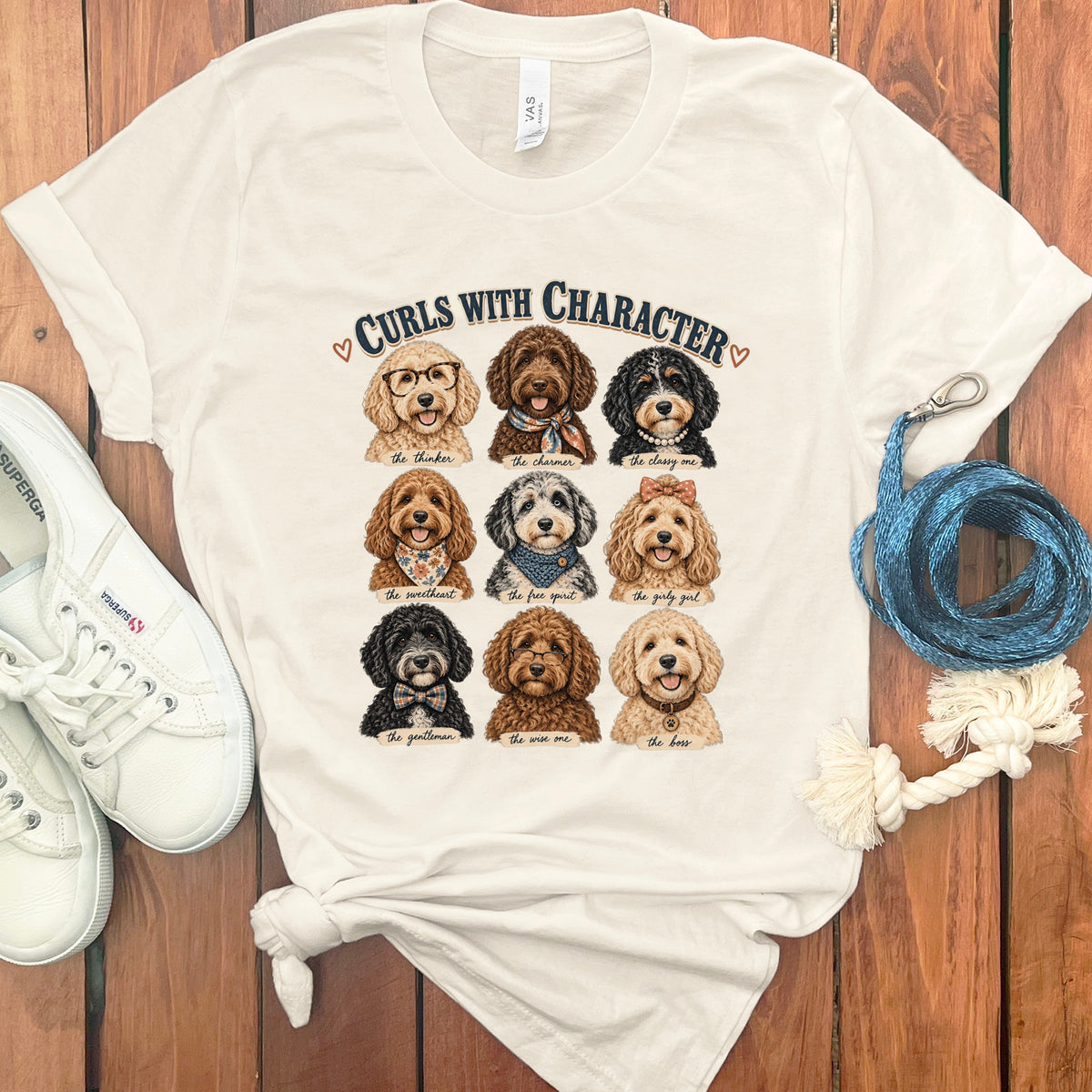 Cream t-shirt with nine dog illustrations and "Curls with Character" text.